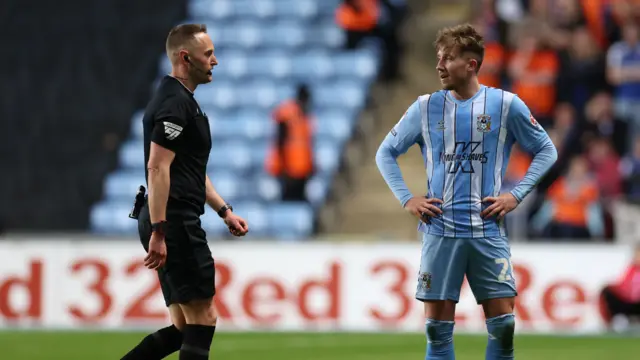 Referee James Bell leaves the field