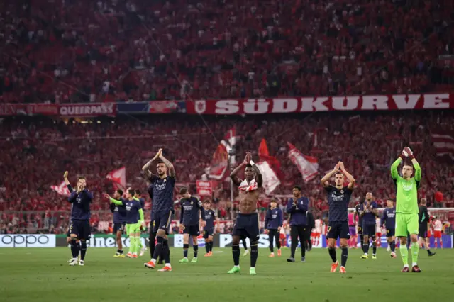 Madrid players applaud the travelling fans from the pitch at full time