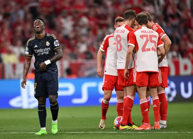 Vinicius laughs as Bayern players debrief after conceding the opening goal