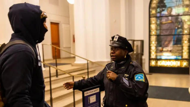 A lone police officer reacts as multiple demonstrators enter into Hamilton Hall where they proceeded to barricade themselves in the academic building which has been occupied in past student movements, on Tuesday, April 30, 2024 in New York City