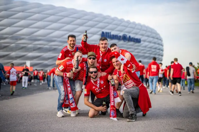 Bayern fans take a picture outside the ground