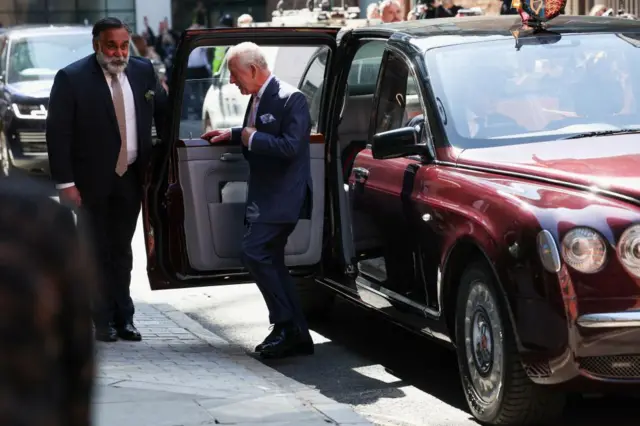 The King steps out of his car on his visit to the central London cancer centre