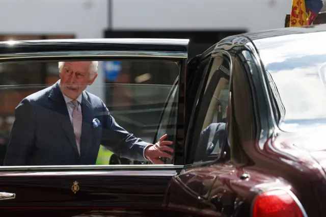 A photo of King Charles III getting back into his car