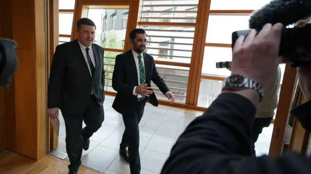 Scotland's First Minister Humza Yousaf arrives in parliament.