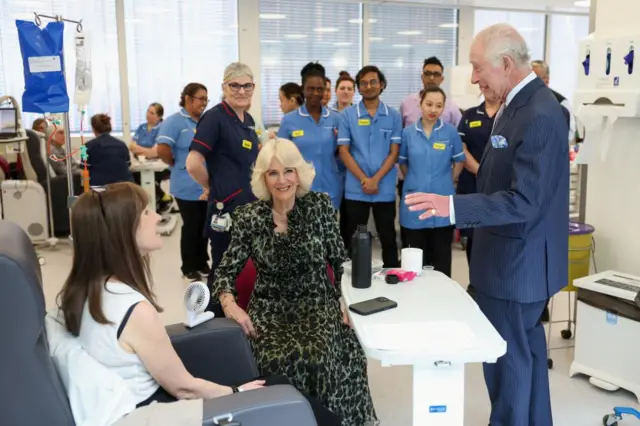 The King and Queen meet a cancer patient with staff standing in the background