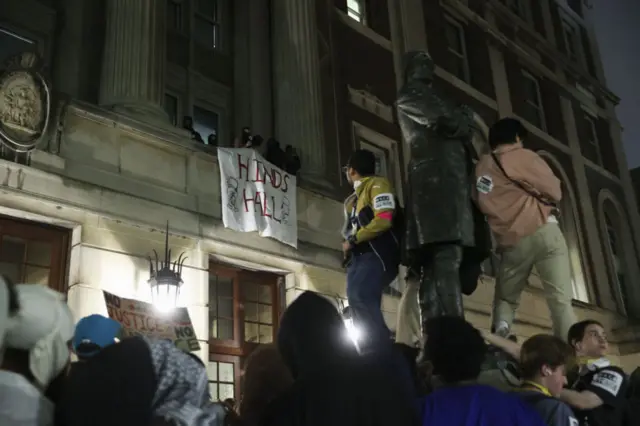 A group of Columbia University students, advocating for Palestinians, access the iconic Hamilton Hall building as they gather to stage a demonstration at the campus in New York, United States on April 30, 2024.