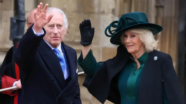 Britain's King Charles III and Queen Camilla wave to crowds as they attend a church service at Windsor Castle and are dressed in a suit and a green dress