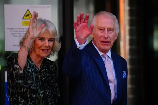 King Charles and Queen Camilla waving