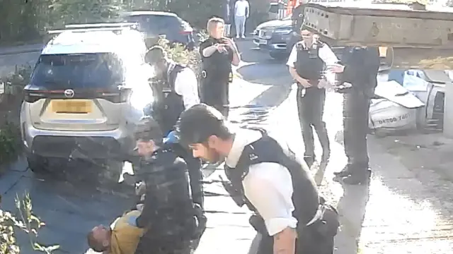 Alleged attacker on the floor being detained by police