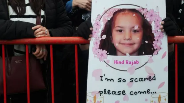 A pro-Palestinian protester holds up a sign with Hind Rajab's final words