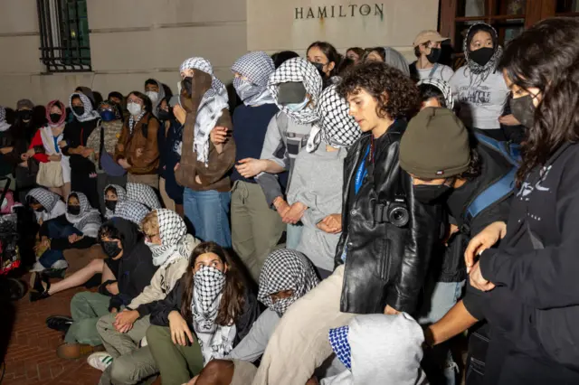 Students linking arms outside Hamilton Hall