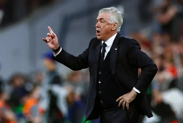 Ancelotti gestures instructions from his technical area