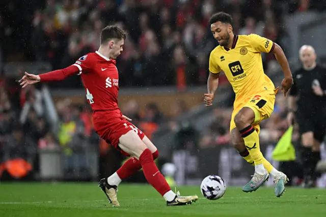 Conor Bradley (L) fights for the ball with Auston Trusty