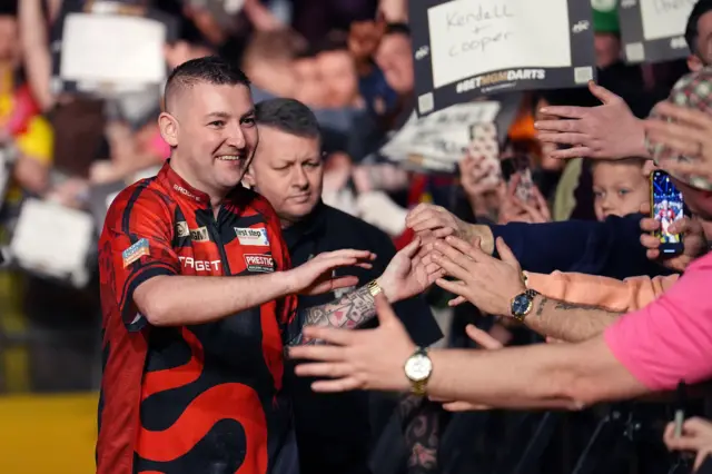 Nathan Aspinall walking on at Manchester's Premier League Darts