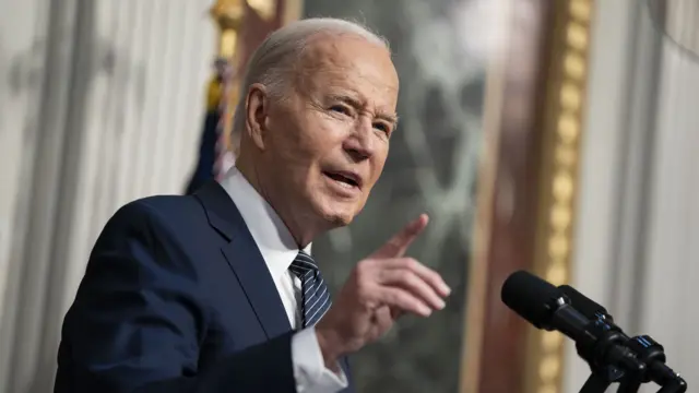 Joe Biden speaking into a microphone