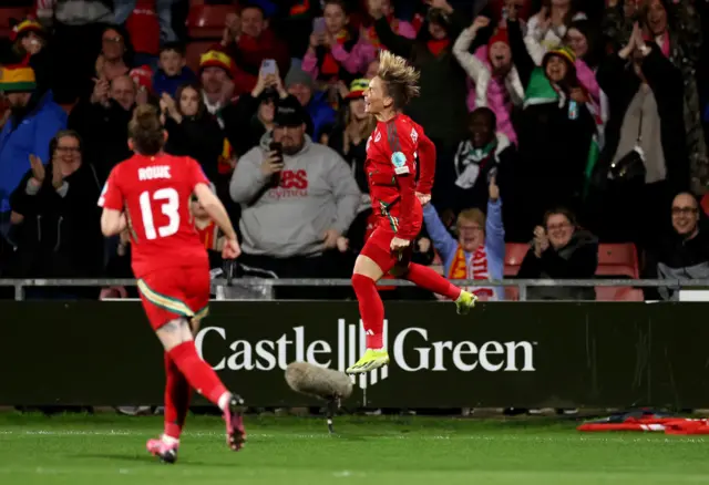 Jess Fishlock jumps in the air to celebrate