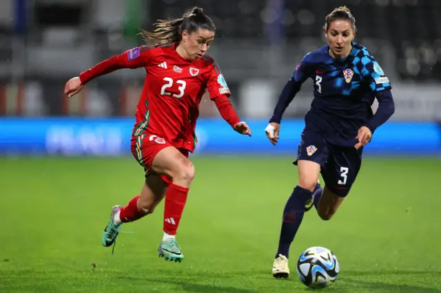 Wales' Ffion Morgan runs with the ball