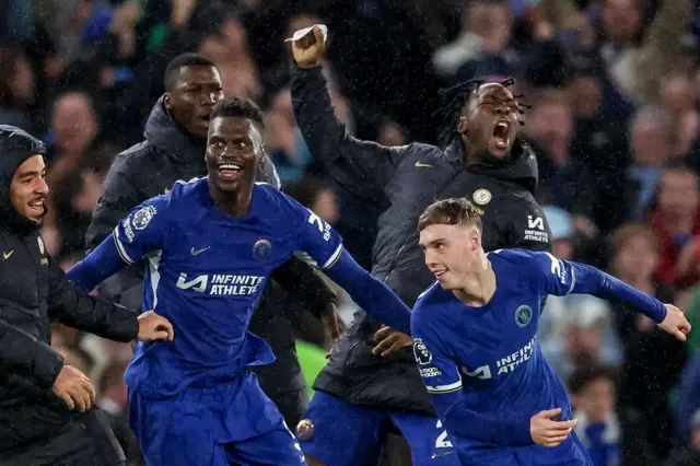 Chelsea players celebrate after a Cole Palmer goal against Manchester United