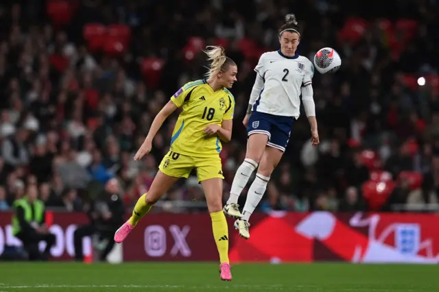 Lucy Bronze challenges for a header