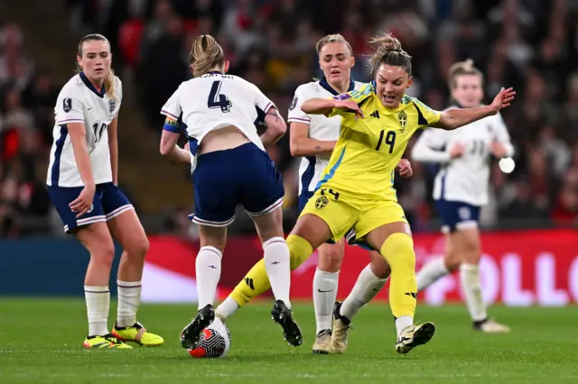 Johanna Rytting Kaneryd of Sweden is challenged by Georgia Stanway and Keira Walsh of England during the UEFA EURO 2025 Women's Qualifiers match between England and Sweden at Wembley Stadium