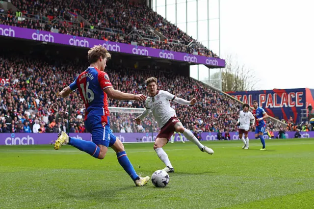 John Stones of Manchester City attempts to stop a cross from Joachim Andersen