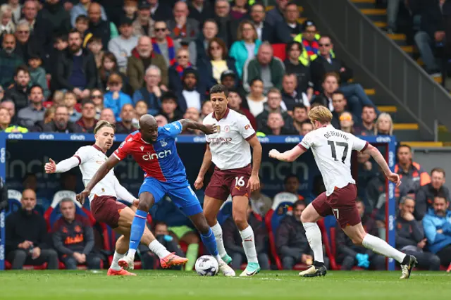 Jean-Philippe Mateta of Crystal Palace is outnumbered by City players