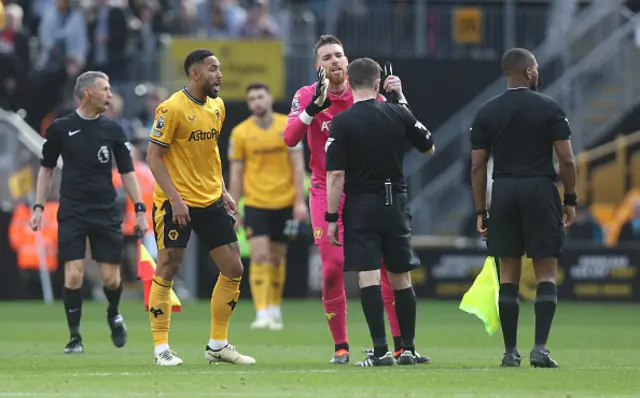 Wolverhampton Wanderers' Matheus Cunha and Jose Sa appeal to referee Tony Harrington