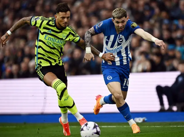 Ben White in action with Brighton & Hove Albion's Julio Enciso