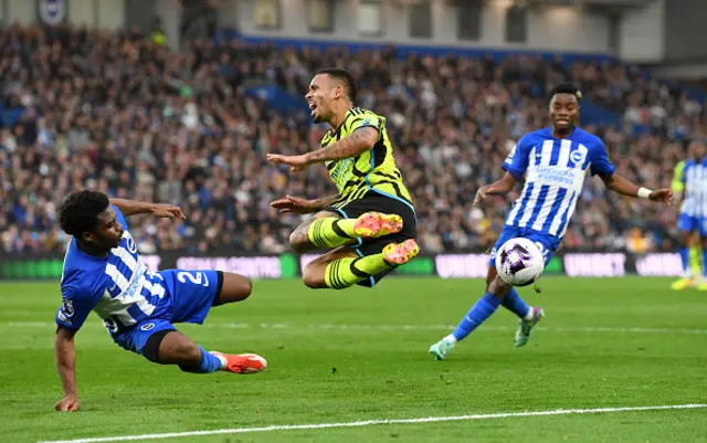 Gabriel Jesus of Arsenal is tackled by Tariq Lamptey