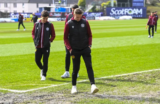 Motherwell players test the conditions at Dens Park