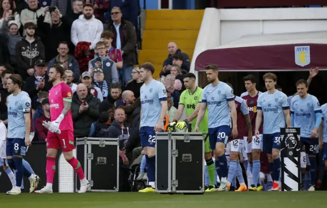 Mathias Jensen leads his teammates out before the match