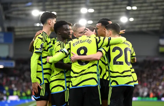 Arsenal players celebrate with Saka after his goal