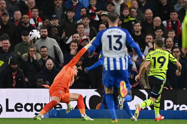 Leandro Trossard chips the ball over the goalkeeper