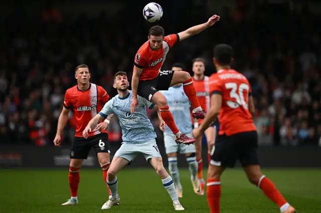 Jordan Clark (C) wins a header under pressure from Ryan Christie