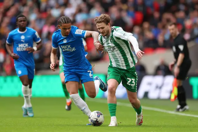 Jadel Katongo of Peterborough United battles for possession with Kieran Sadlier of Wycombe Wanderers during the Bristol Street Motors Trophy Final