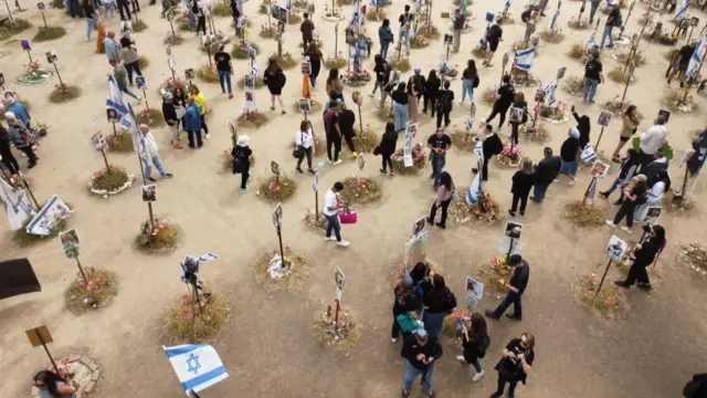 Families gather at the memorial site for victims killed during the Nova music festival in the October 7 Hamas attacks, near the border with Gaza, in southern Israel