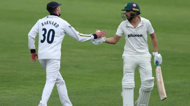 Kashif Ali shakes hands with Ed Barnard