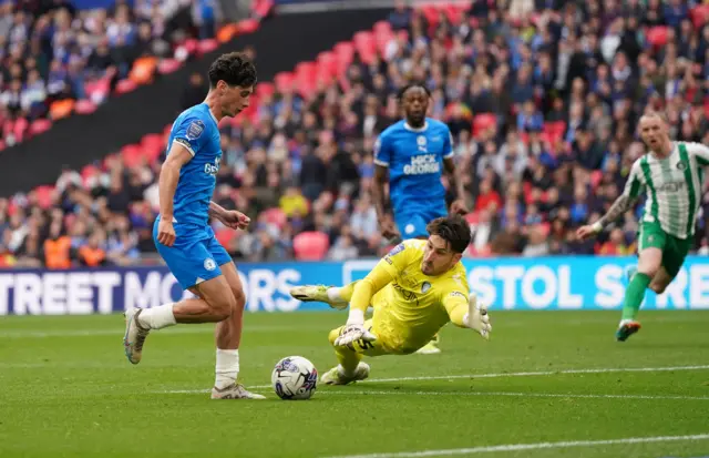 Peterborough United's Joel Randall attempts to bring the ball around Wycombe Wanderers's goalkeeper Franco Ravizzoli during the Bristol Street Motors Trophy final at Wembley Stadium, London