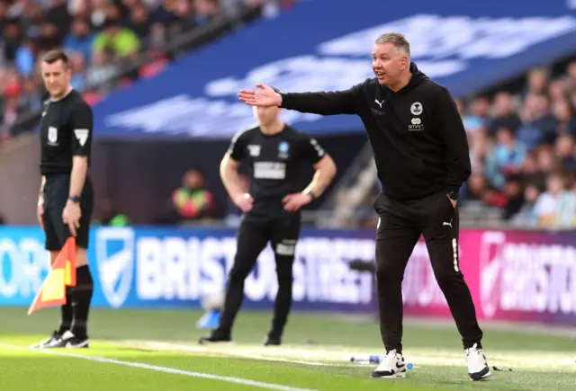 Peterborough boss Darren Ferguson gives instructions to his side