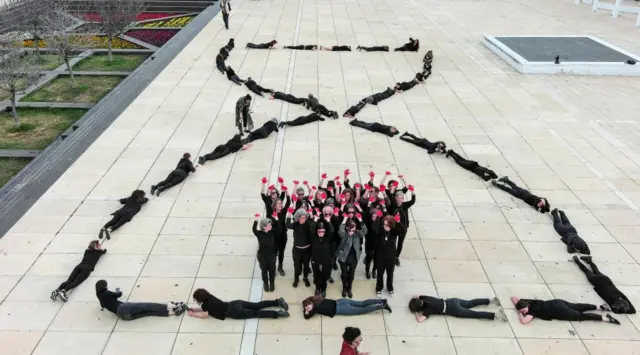 A drone view shows relatives of hostages kidnapped during the deadly October 7 attack on Israel by Palestinian Islamist group Hamas from Gaza, form the shape of an hour glass as part of an installation called "Time Kills", demanding Israeli Prime Minister Benjamin Netanyahu's government does everything they can to bring the hostages home, in Tel Aviv, Israel, April 7, 2024.