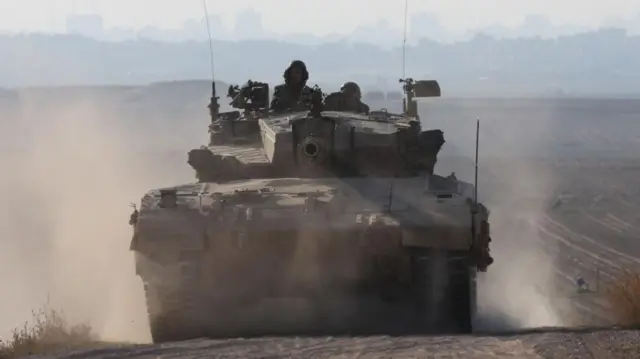 An Israeli army tank moves along the border with Gaza in southern Israel