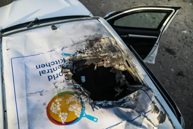 A destroyed car with the NGO World Central Kitchen's logo is pictured on Al Rashid road, between Deir Al Balah and Khan Younis in the southern Gaza Strip, 2 April 2024.