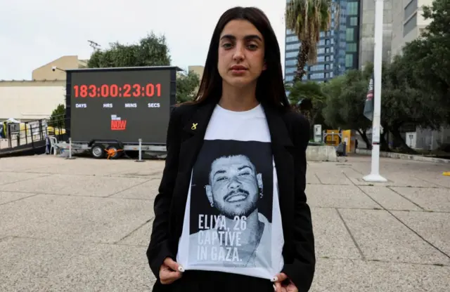 Ziv Abud, the girlfriend of hostage Eliya Cohen, who was kidnapped during the October 7 attack on Israel by Palestinian Islamist group Hamas from Gaza, shows her t-shirt with a picture of Eliya during an interview with Reuters, in Tel Aviv, Israel, April 7, 202