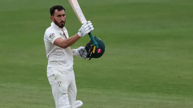 Kashif Ali raises his bat