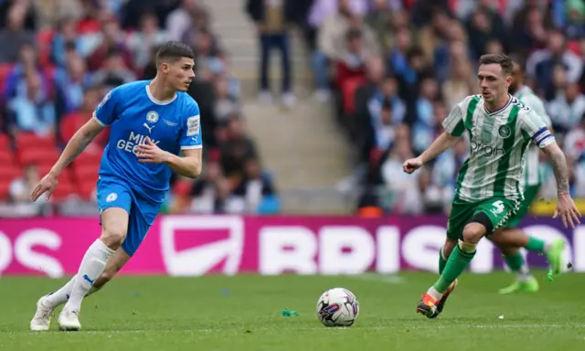 Ronnie Edwards of Peterborough United under pressure from Josh Scowen of Wycombe Wanderers during the Bristol Street Motors Trophy Final