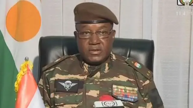 This video frame grab image obtained by AFP from ORTN - Télé Sahel on July 28, 2023 shows General Abdourahamane Tiani, Niger's new strongman, speaking on national television and reads a statement.