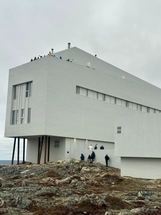 People gather to watch the eclipse on and around the Fogo Island Inn in Newfoundland, Canada