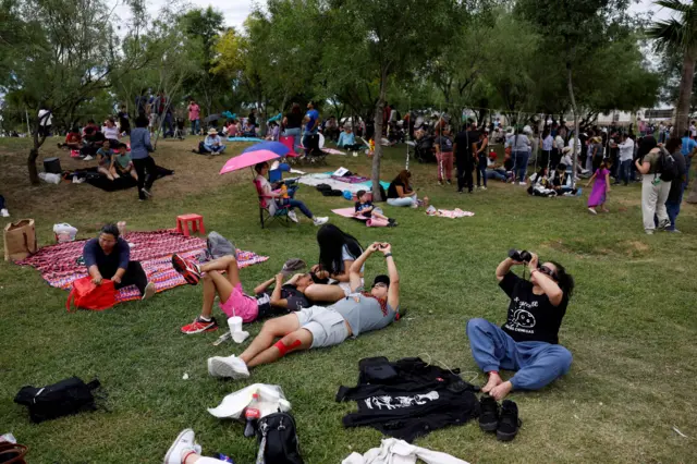 Dozens gather in a park to observe the solar eclipse, in Torreon, state of Coahuila, Mexico