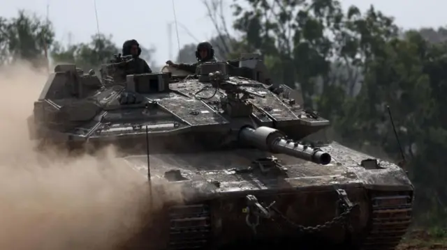 Israeli soldiers on a tank in Khan Yunis