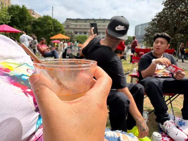 People in Dallas, Texas gather for an eclipse watch party